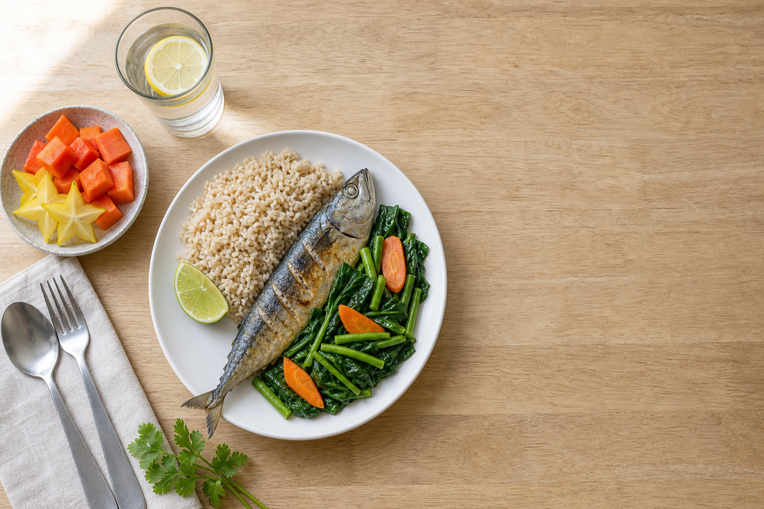 Overhead flat-lay of a balanced Malaysian meal with brown rice, grilled ikan kembung, stir-fried kailan, papaya and water — a healthy-eating illustration for a belly fat guide.