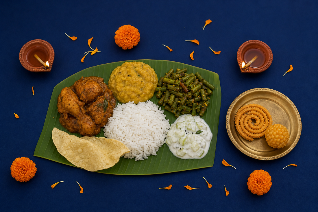 Balanced Deepavali banana-leaf meal with a small plate of murukku and laddu, clay diyas and marigolds